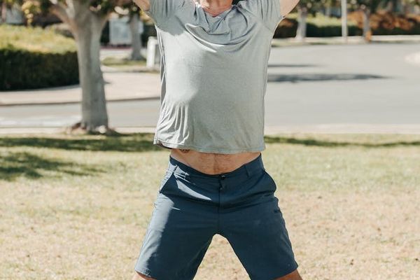 Person mid-jump during a cardio exercise, showing motion and energy.